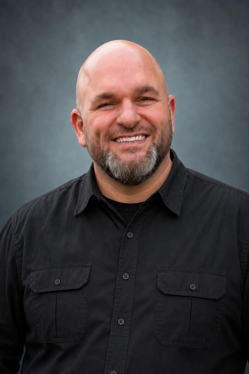 Brian Urlage smiling in a professional portrait